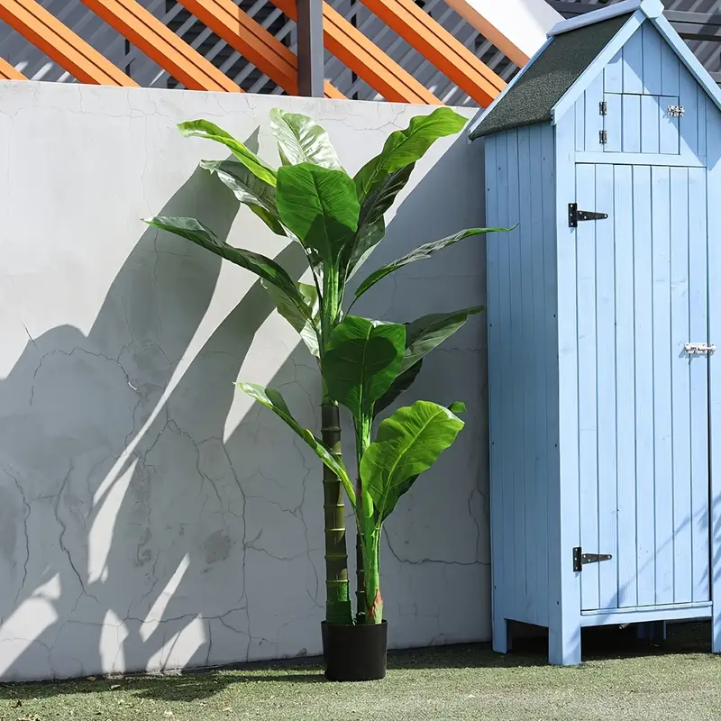 Sztuczna roślina w doniczce z szerokimi liśćmi